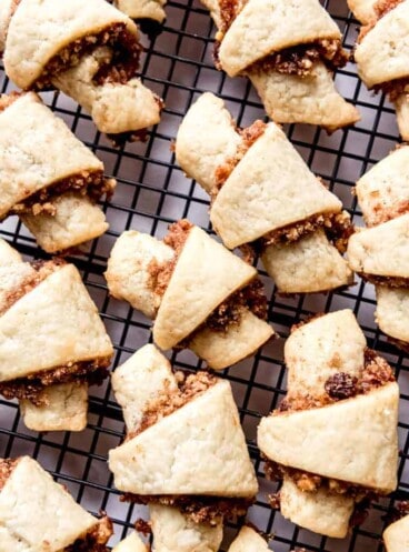 An image of cinnamon walnut rugelach on a wire cooling rack.