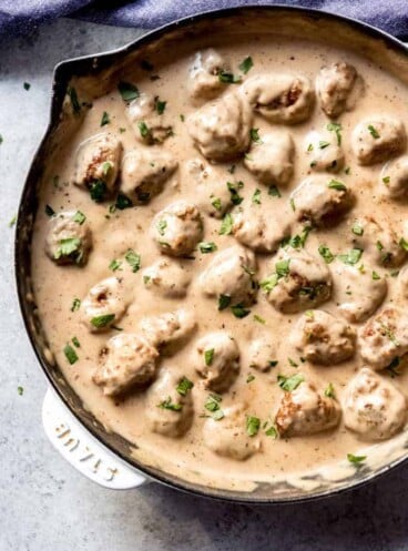 a skillet full of swedish meatballs and garnished