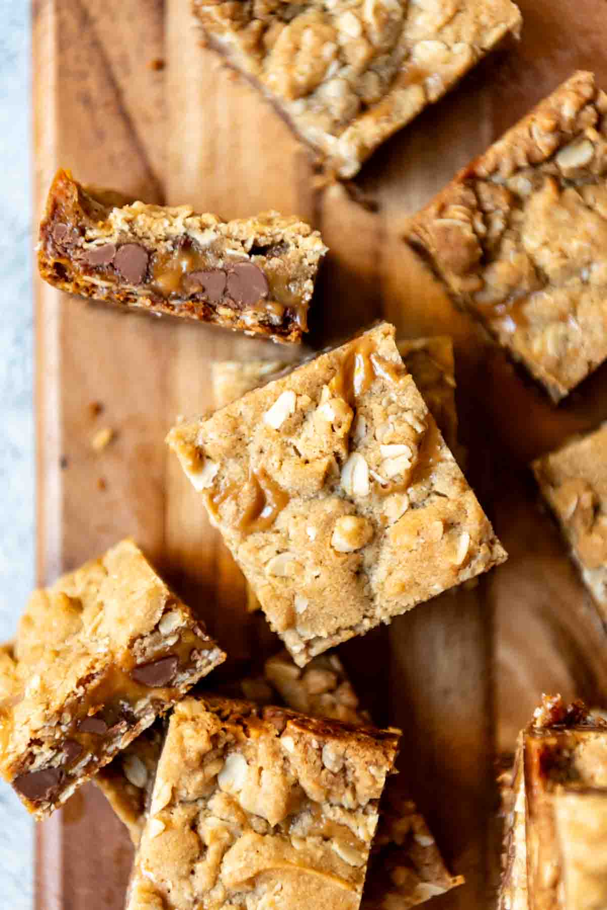 An image of chocolate oatmeal caramel carmelita bars cut into squares.