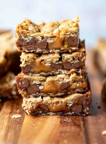 An image of carmelita bars with melted caramel stacked on top of each other.