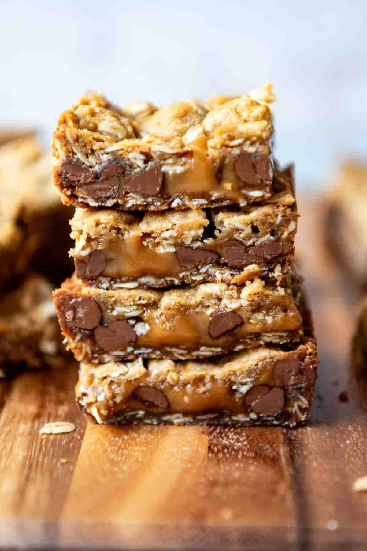 An image of carmelita bars with melted caramel stacked on top of each other.