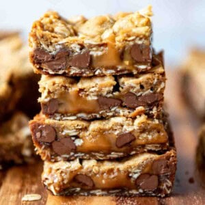 An image of carmelita bars with melted caramel stacked on top of each other.