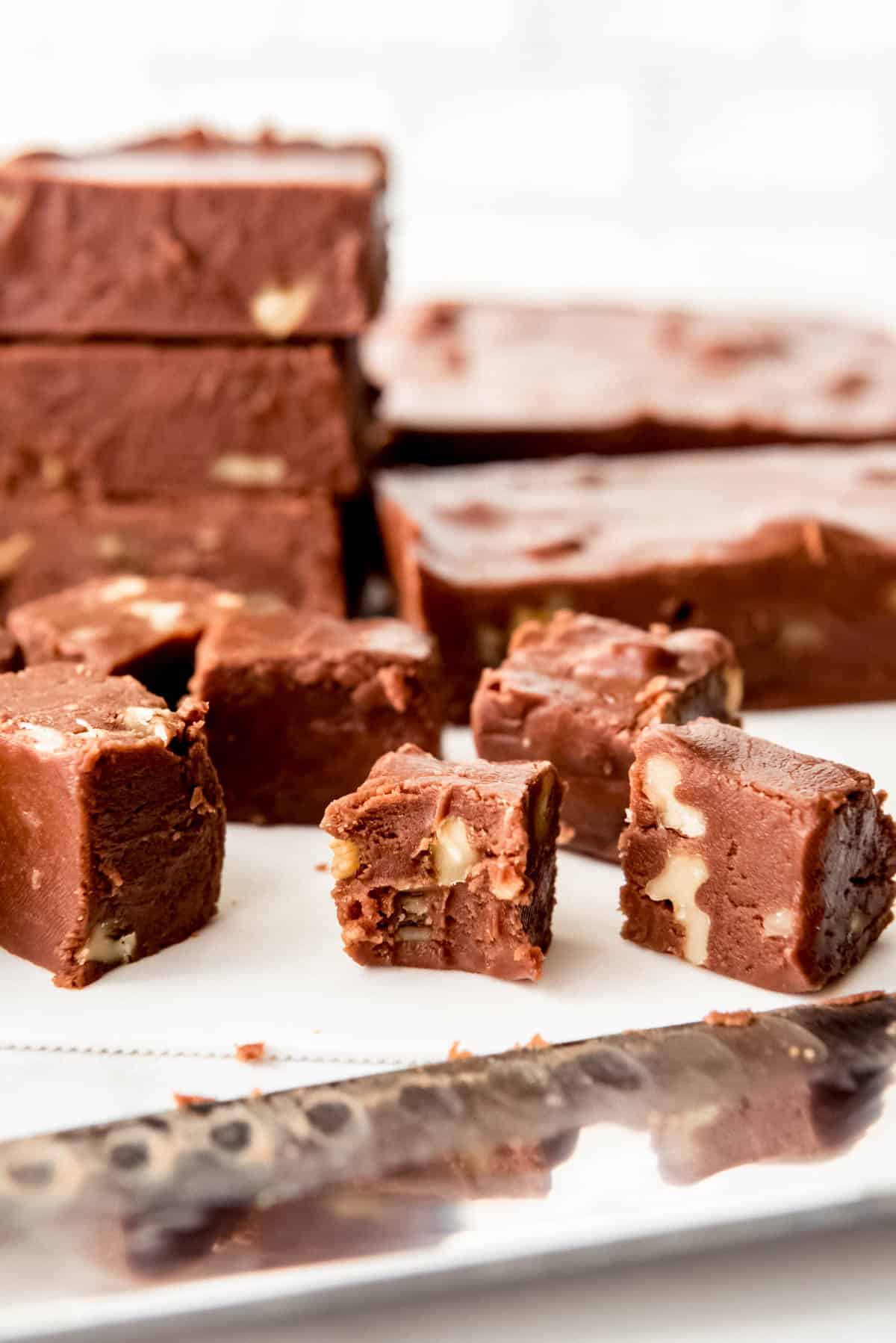 An image of a piece of chocolate walnut fudge with a bite taken out of it.