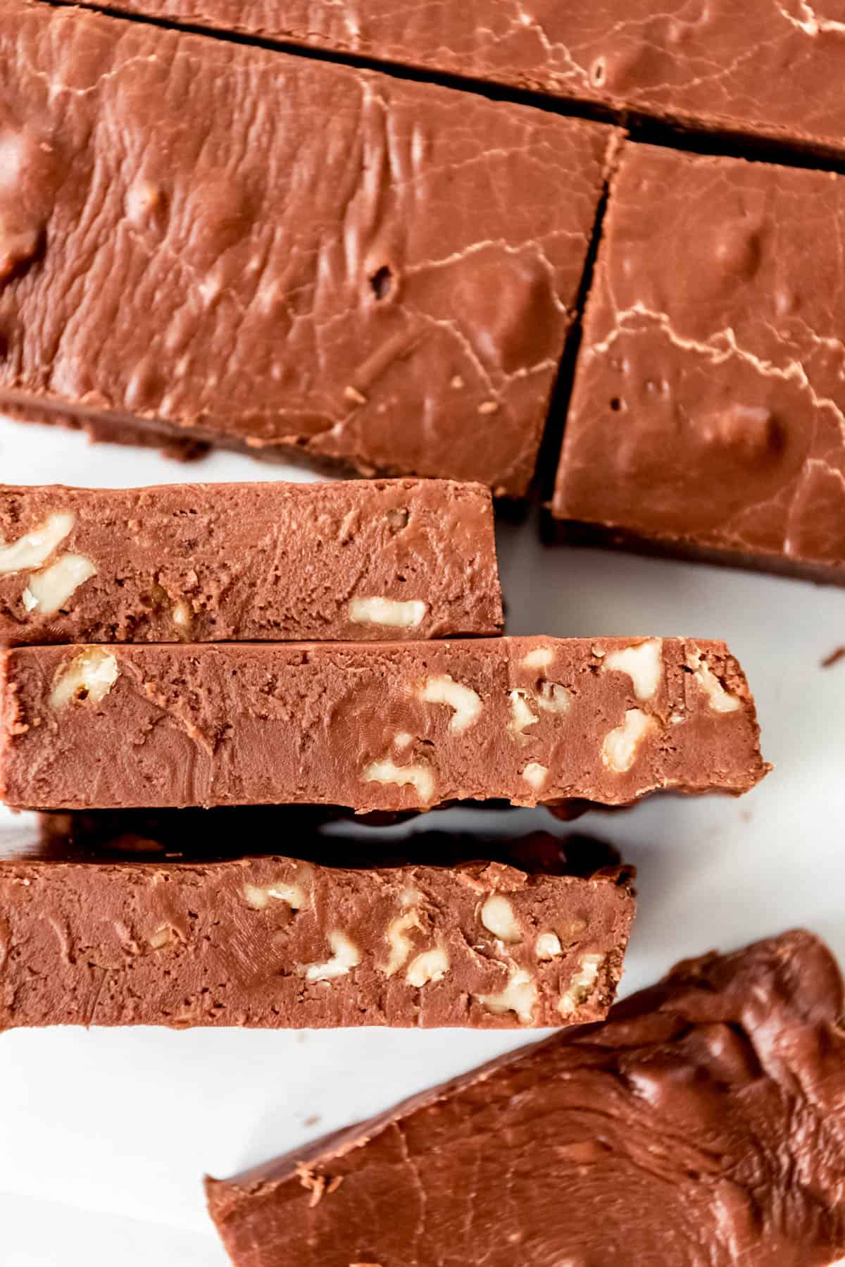 An image of rich, creamy chocolate fudge with walnuts.