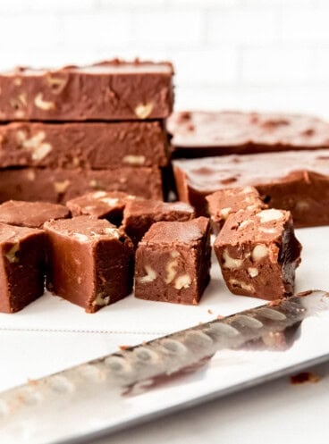 An image of small squares of homemade chocolate walnut fudge.