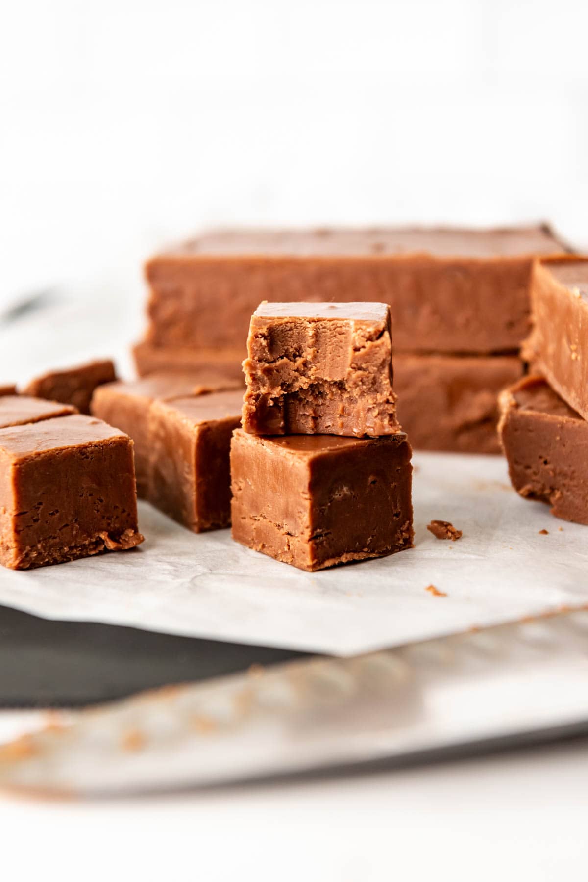 An image of a piece of easy homemade fudge with a bite taken out of it.