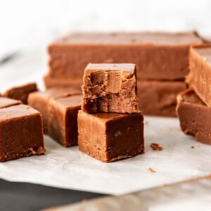 An image of a piece of easy homemade fudge with a bite taken out of it.