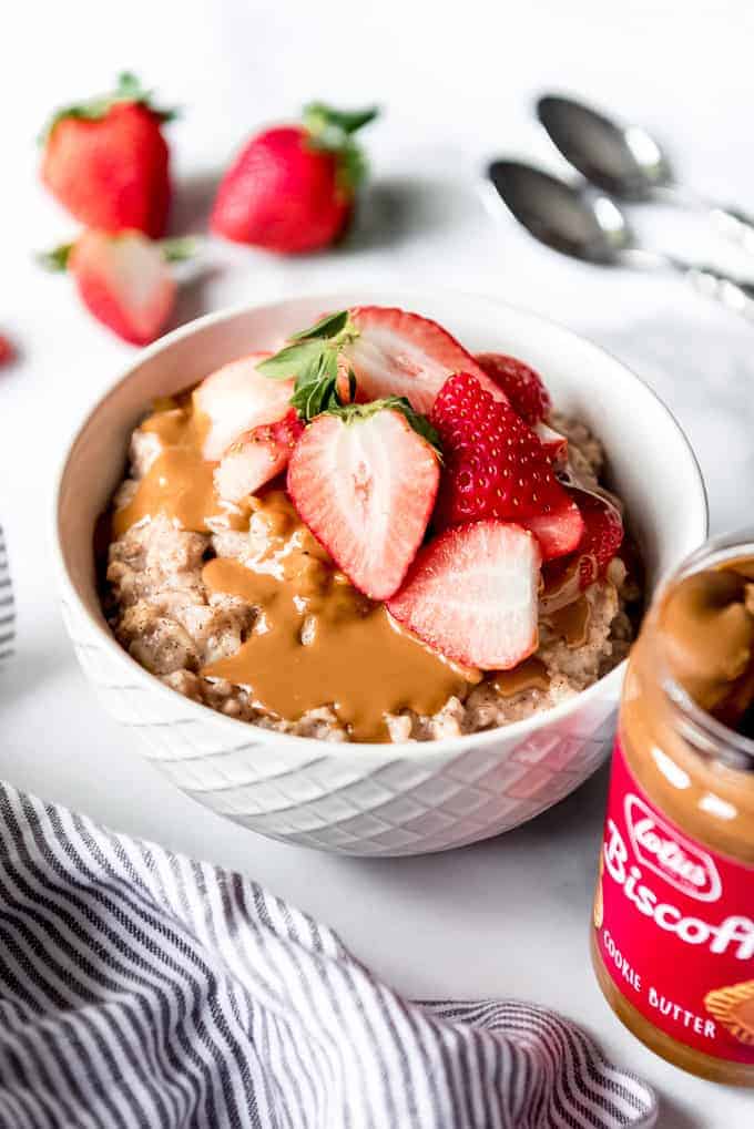 An image of a bowl of oatmeal topped with strawberries and cookie butter.