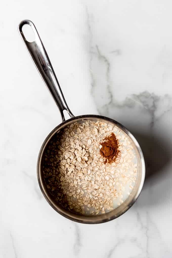 An image of oats, milk, water, and cinnamon in a pot.