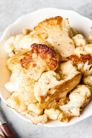 An image of a bowl of oven roasted cauliflower.