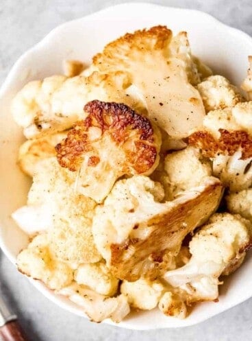 An image of a bowl of oven roasted cauliflower.
