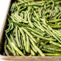 An image of roasted green beans on a baking sheet.