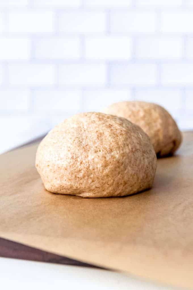 An image of a ball of whole wheat pizza dough.
