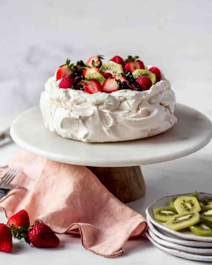 An image of a classic pavlova on a cake stand.