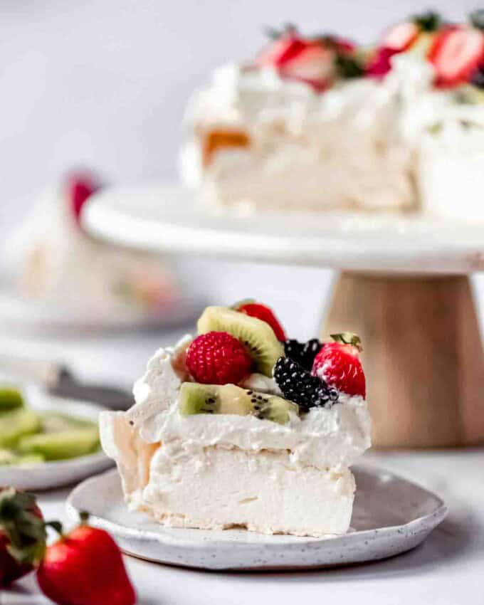 An image of a slice of light and fluffy homemade pavlova cake.