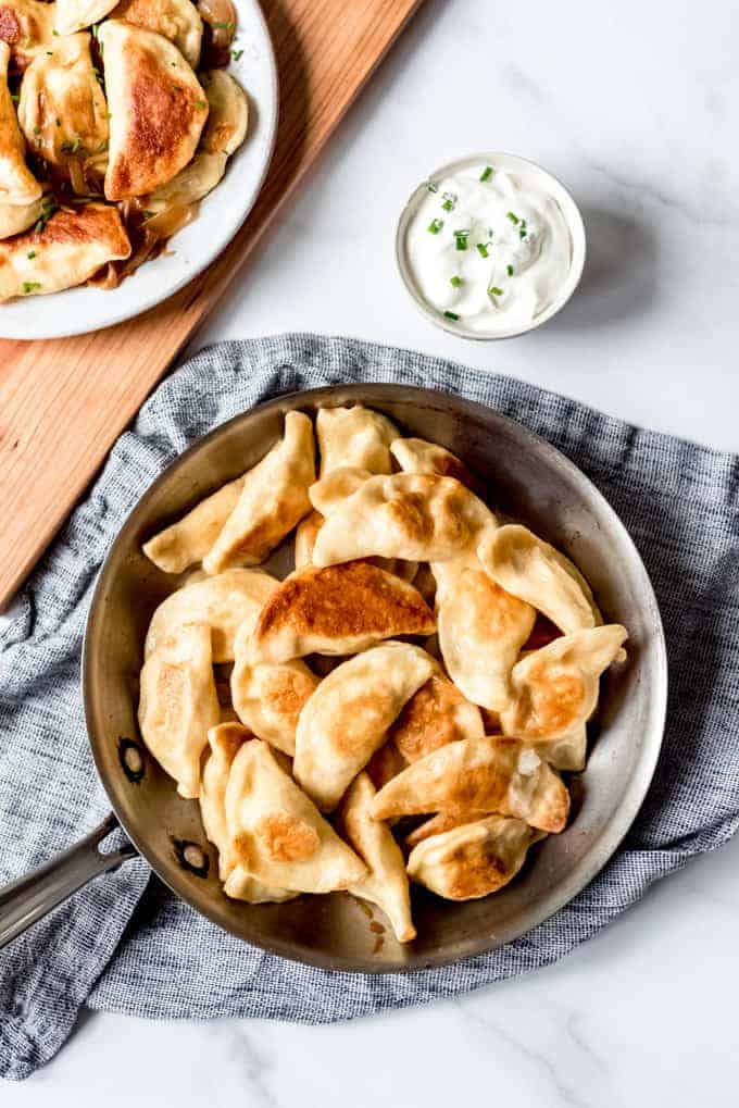 An image of homemade pierogies that have been fried in butter until crispy.