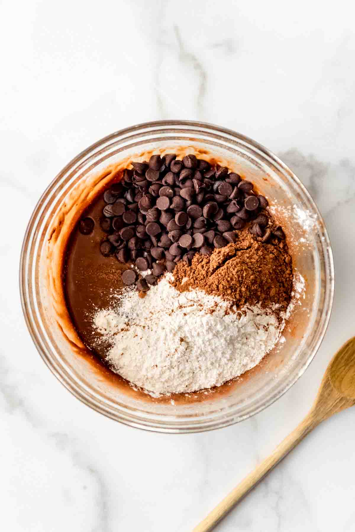 Adding dry ingredients to brownie batter.