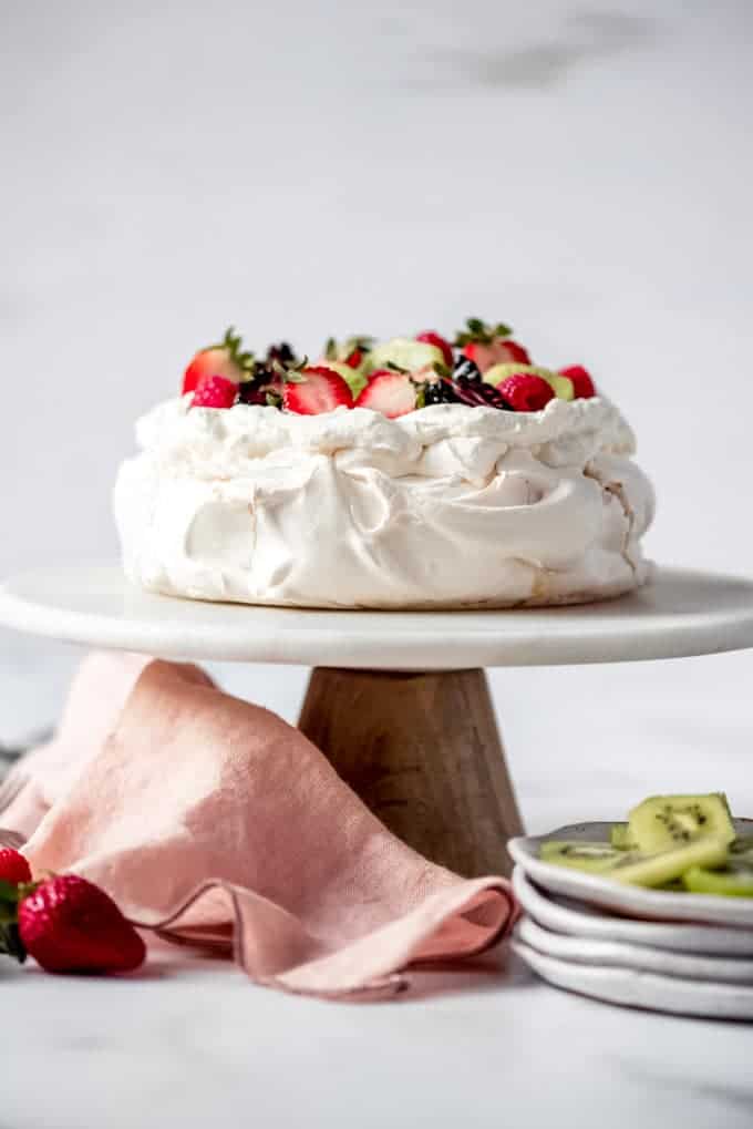 An image of a classic pavlova on a cake stand.