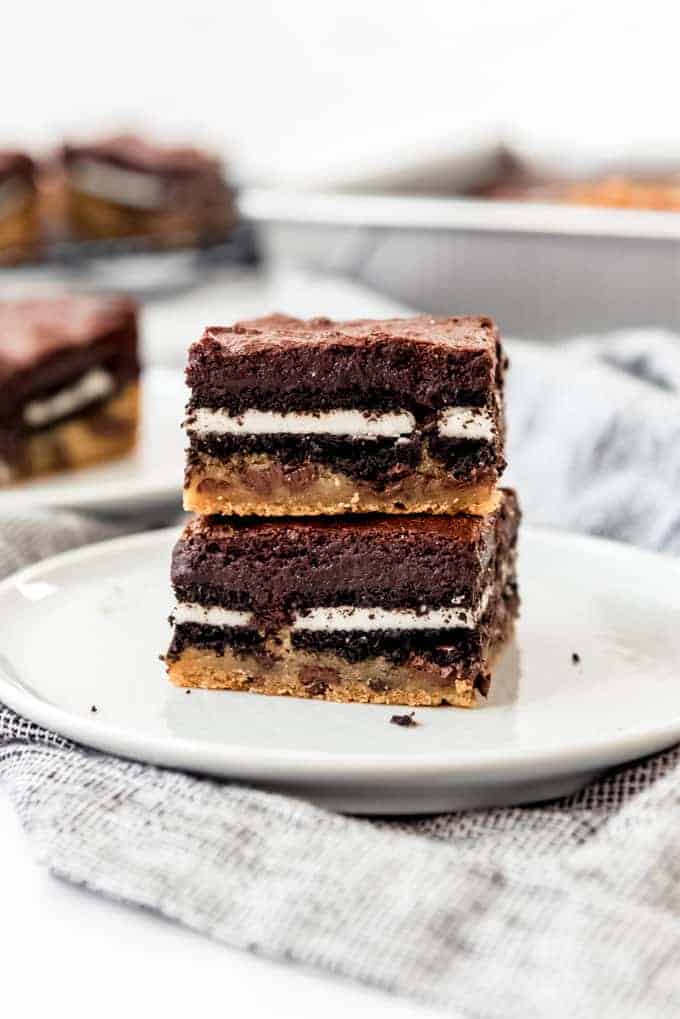 Slutty brownies stacked on a white plate.