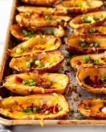 An image of loaded potato skins on a baking sheet.