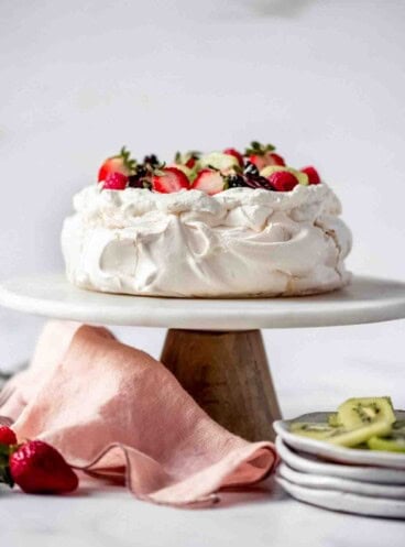 An image of a classic pavlova on a cake stand.