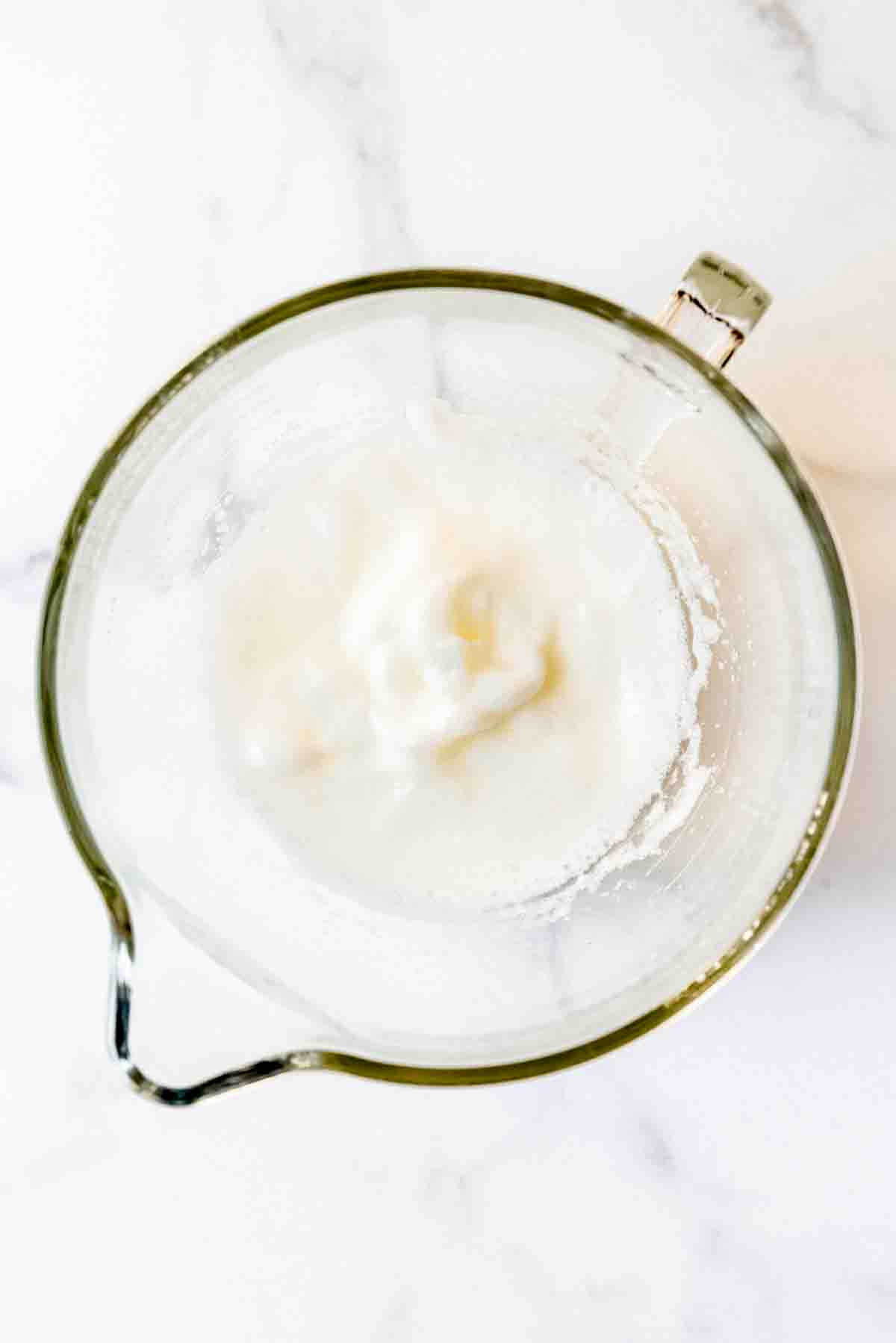 Whipped egg whites in a bowl.