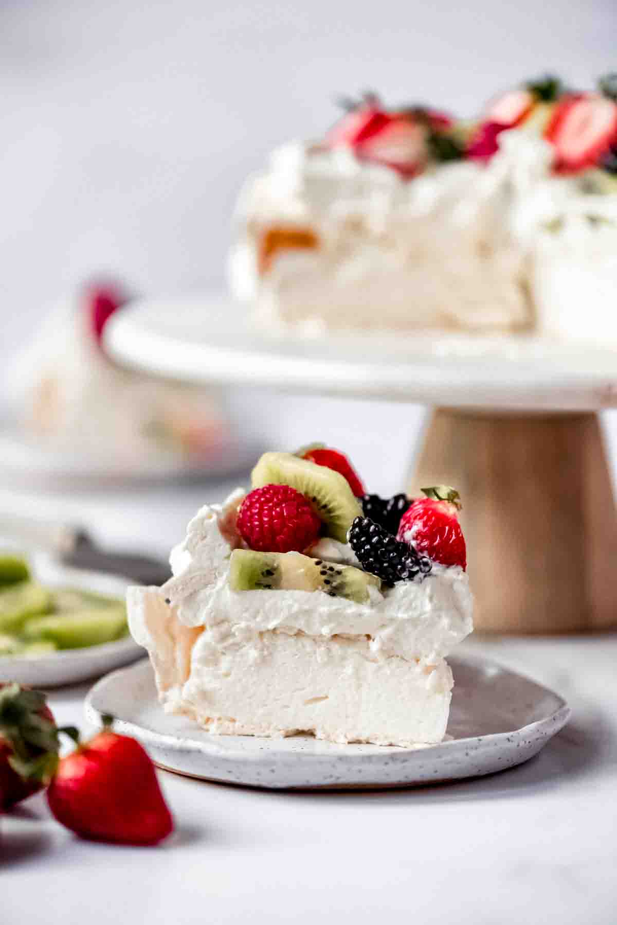 An image of a slice of light and fluffy homemade pavlova cake.