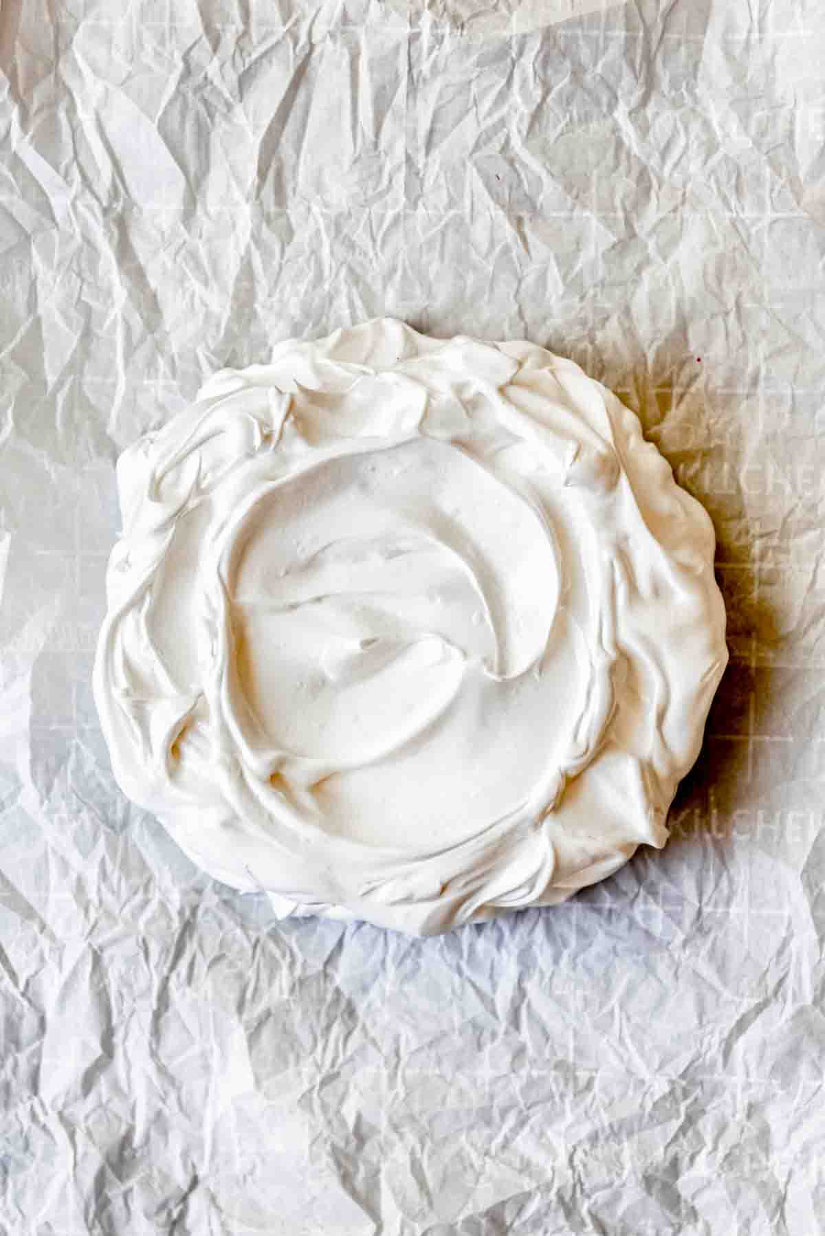 An overhead image of a baked pavlova.