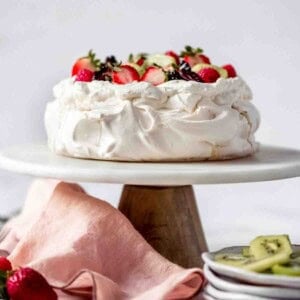 An image of a classic pavlova on a cake stand.