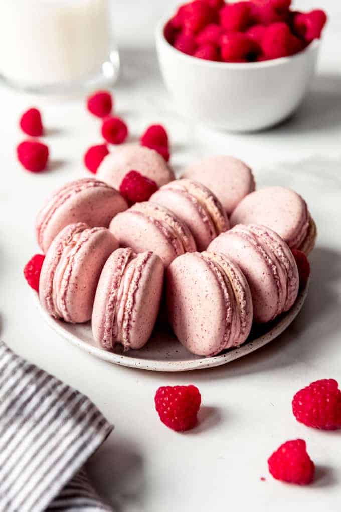 An image of pink raspberry macarons on a plate.