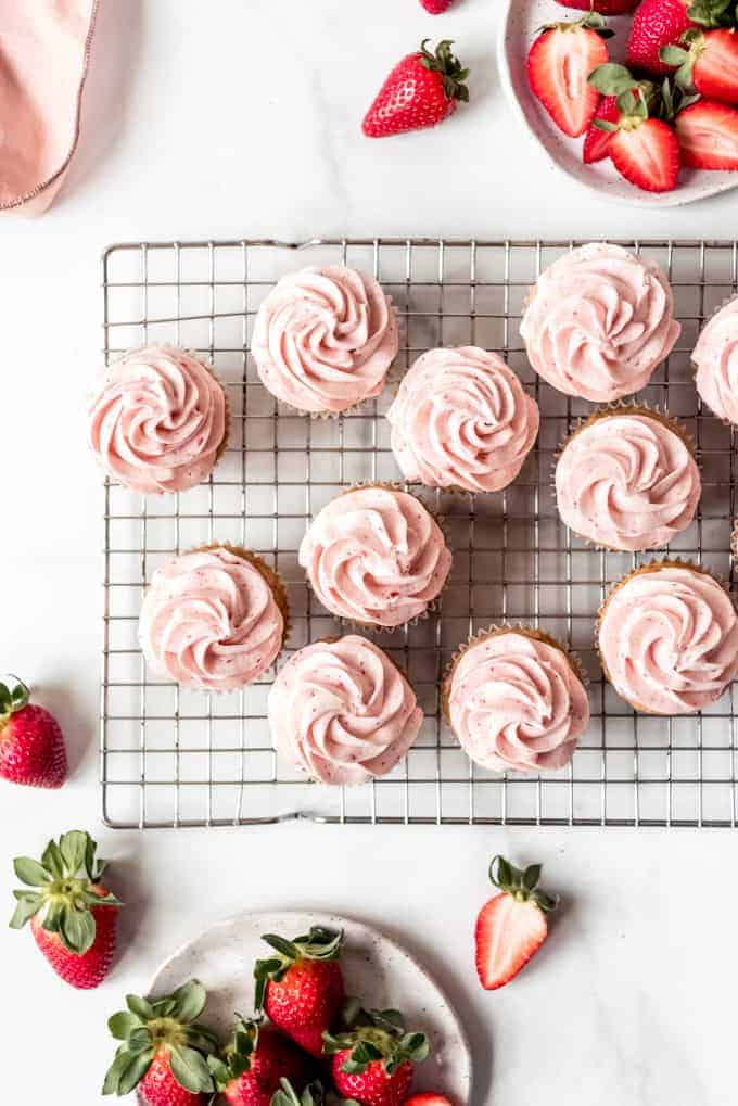 An image of swirled strawberry frosting on cupcakes.