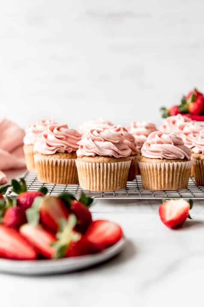 An image of moist strawberry cupcakes with strawberry buttercream frosting piped on top.