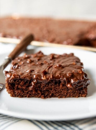 An image of a slice of chocolate Texas sheet cake on a plate.