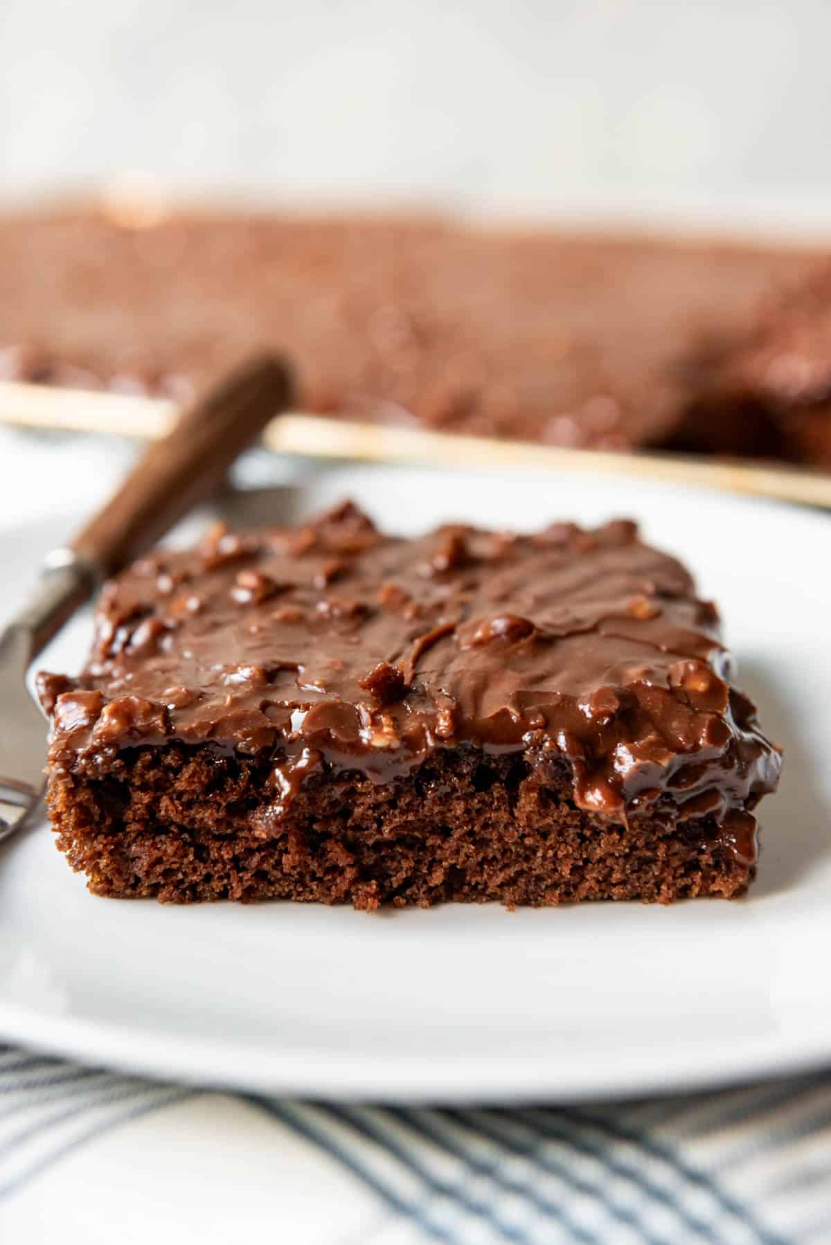 An image of a slice of chocolate Texas sheet cake on a plate.