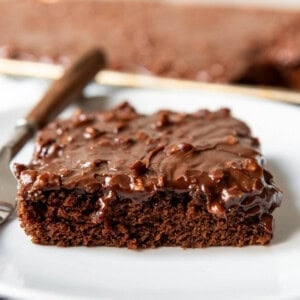 An image of a slice of chocolate Texas sheet cake on a plate.