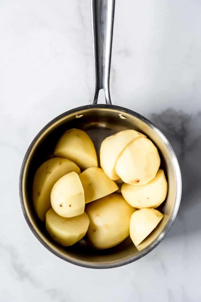An image of potatoes in a pot for boiling and mashing.