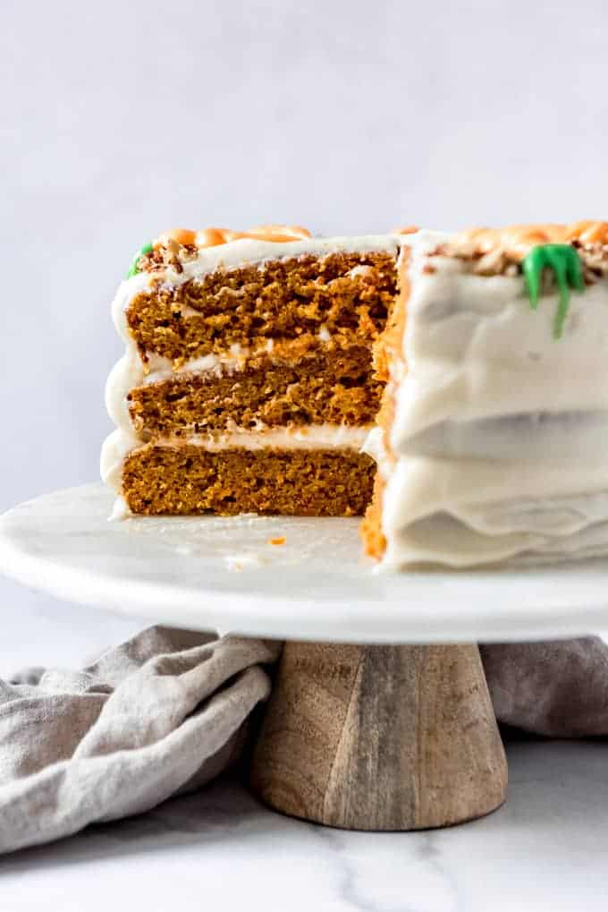 An image of a three-layer Easter carrot cake that has been sliced into.