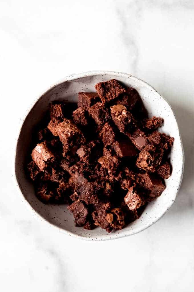 A bowl full of chocolate brownie pieces.