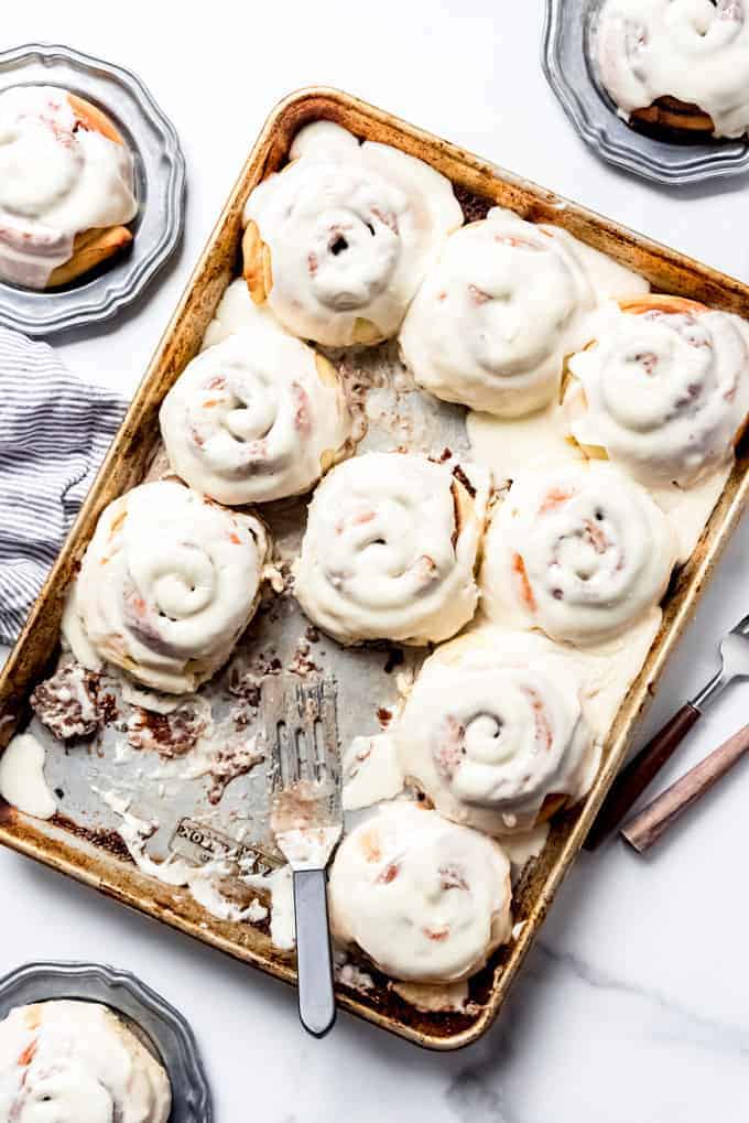 An image of soft, fluffy cinnamon rolls covered in cream cheese frosting.