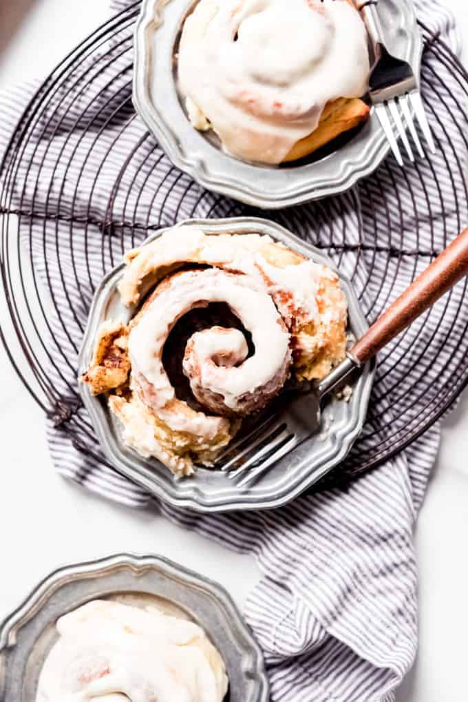 An image of a cinnamon roll on a plate with a fork.