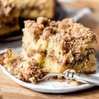 An image of a piece of sour cream coffee cake with a bite taken out of it.