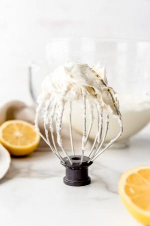 An image of a kitchenaid whisk attachment covered in homemade lemon buttercream frosting.
