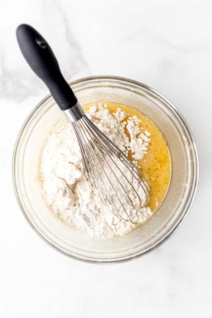 An image of flour being added to homemade cupcake batter.