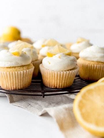 An image of lemon cupcakes on a wire cooling rack.
