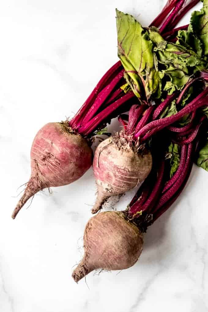 An image of fresh beets with their stems still on.