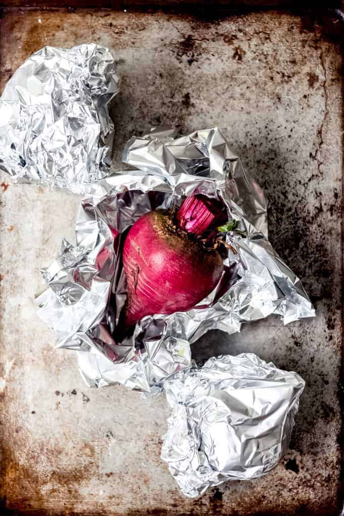 An image of a roasted beet wrapped in tinfoil.