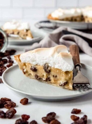 An image of a slice of homemade Sour Cream Raisin Pie with meringue.