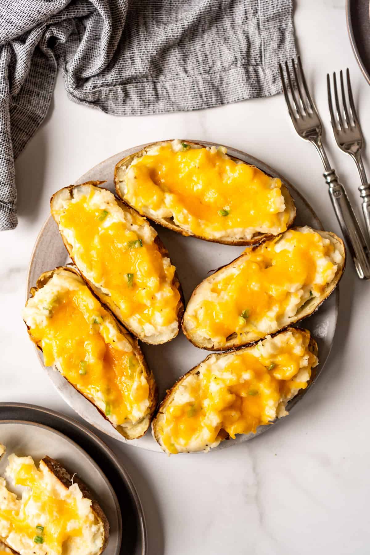 An overhead image of twice baked potatoes on a serving plate.