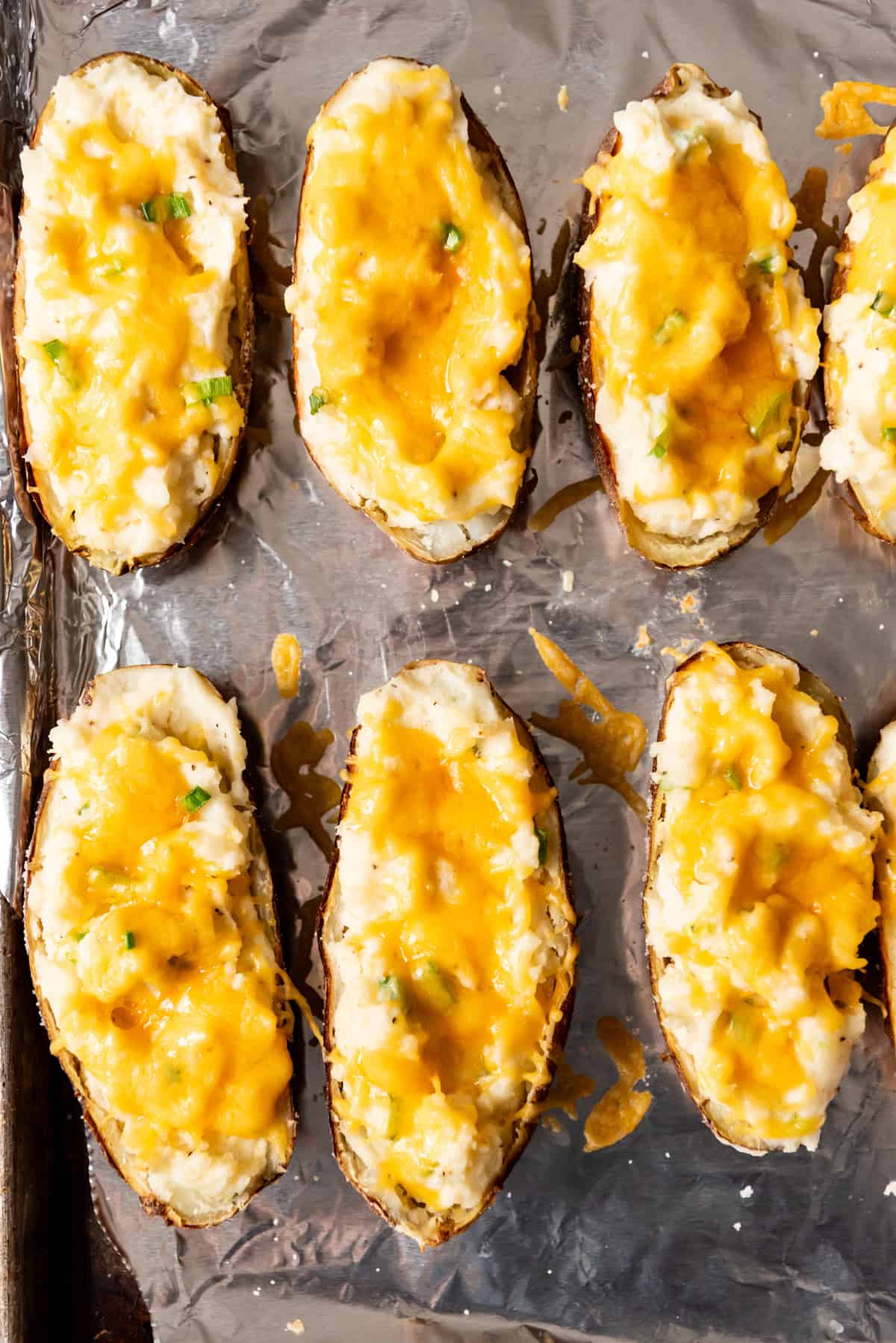 An image of loaded mashed potatoes in potato skins.