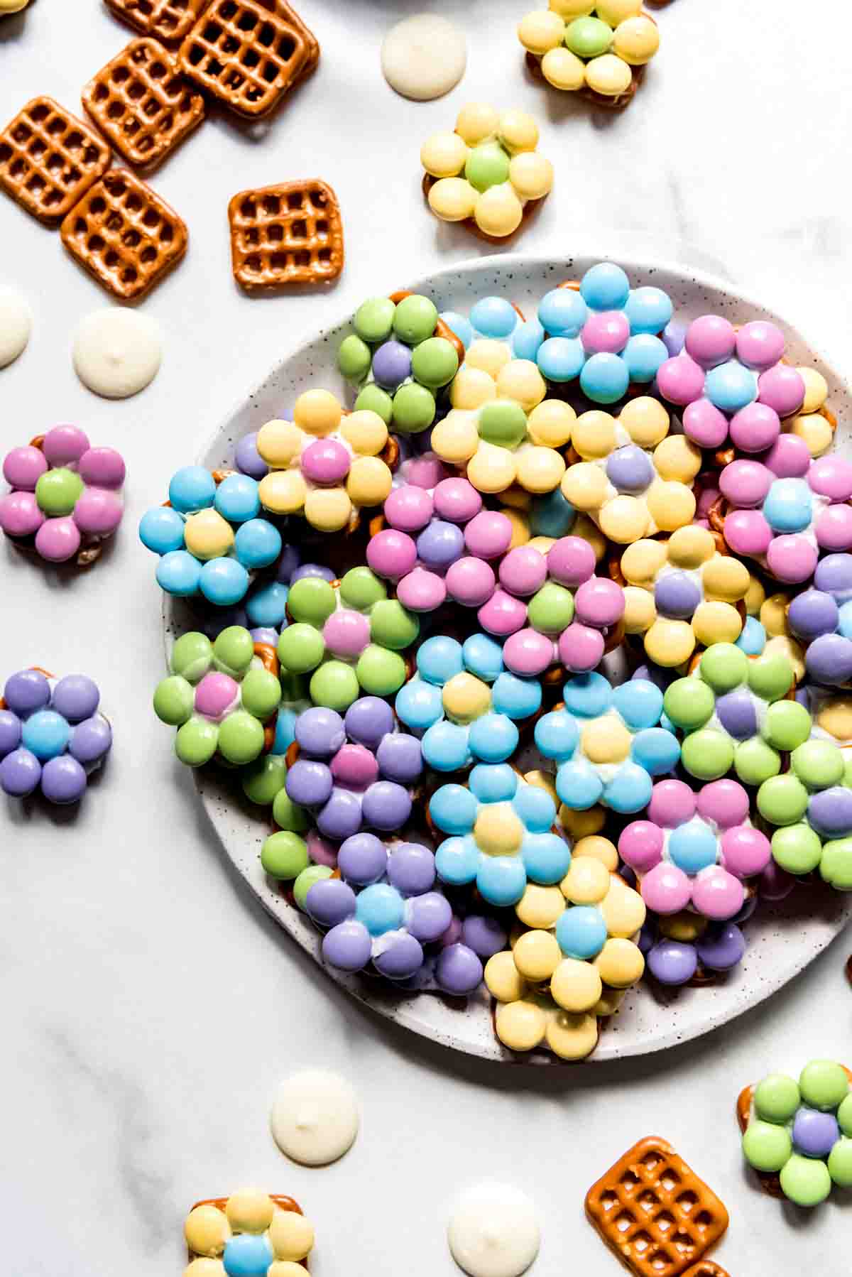 An overhead image of pretzel candies made with M&M's to look like flowers.